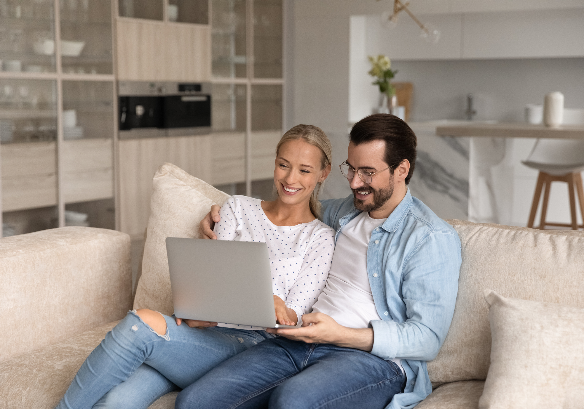 Couple meeting with The Police Credit Union's Virtual Branch team member on laptop while at home to discuss accounts. 
